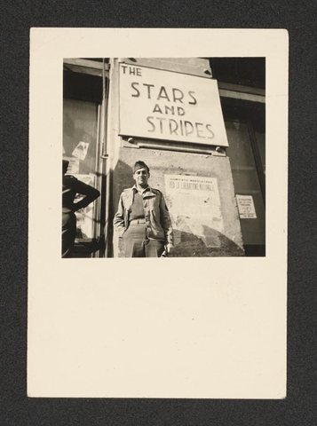 From Nicholas (Mickey) Brecher’s wartime photo album (1942–45): a soldier outside an office of “The Stars and Stripes”, the army newspaper, with notices in Ital